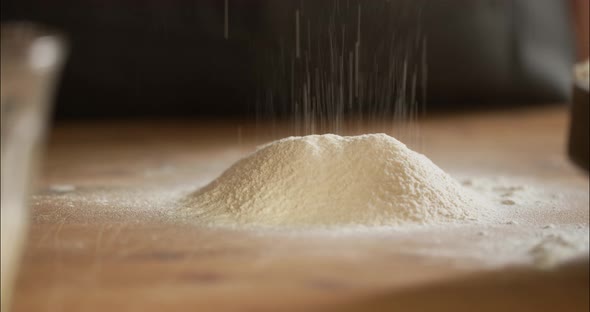 Woman sieving flour for home made Maultaschen dough