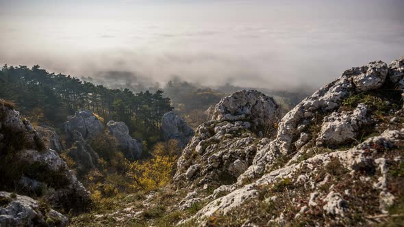  Timelapse with rocky mountains and inversion, fast movement of clouds