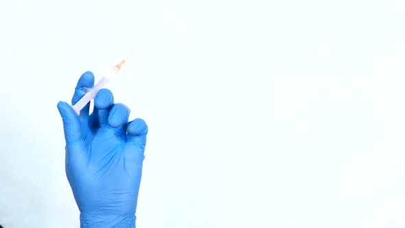 Doctor Hand in Medical Gloves Holding Syringe Isolated on White