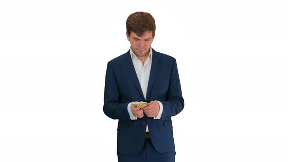 Happy Businessman Counting Money and Tucking It Inside a Jacket Pocket on White Background.