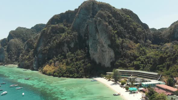 Towering limestone cliff restraining Tonsai Bay in Ko Phi Phi Don Island, Thailand