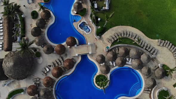 Cancun Mexico Vacation on Aerial View with Hotel Swimming Pool with Beach Umbrellas Beds