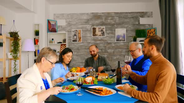 Zoom in Shot of Family Enjoying a Good Red Wine