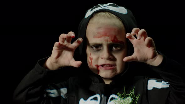 Halloween, Angry Girl with Blood Makeup on Face. Kid Dressed As Scary Skeleton, Posing, Making Faces