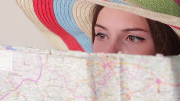 Woman's Face Behind a Map