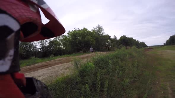 motocross helemt cam rider watching other bikes racing over jump