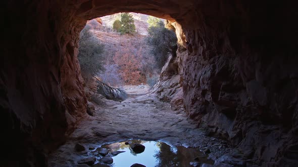 Tunnel carved in sandstone in the Utah desert for water to move under the road