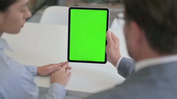 Male and Female Business Person using Tablet with Green Chroma Screen