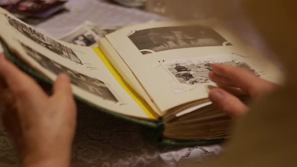 Hand Old Woman Is Looking at Old Photo Album at Home