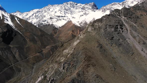 Aerial Drone shot ascending on snowy mountains in Cordillera de los Andes-4K