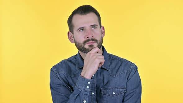 Beard Young Man Thinking About Idea, Yellow Background