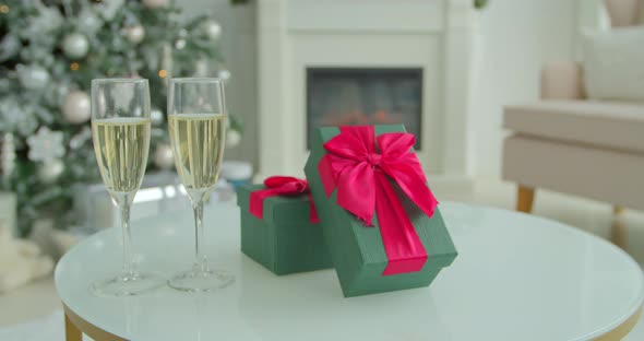 Closeup Champagne Into Glasses on Christmas Tree Bokeh Background Closeup.