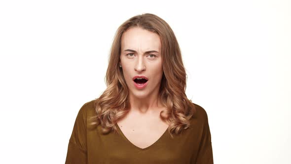 Angry Caucasian Middleaged Female with Long Brown Hair Screaming on White Background