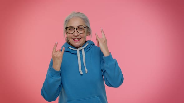 Overjoyed Delighted Crazy Elderly Woman Showing Rock n Roll Gesture By Hands Cool Sign Dancing