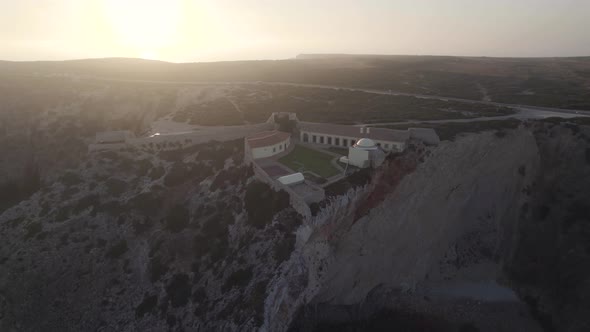 Aerial wide shot of spectacular rock formation in Fortress of Beliche Sagres Algarve Portugal.