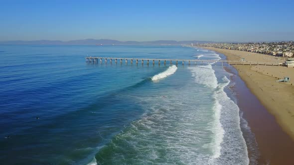 Aerial drone uav view of a pier over the beach and ocean.