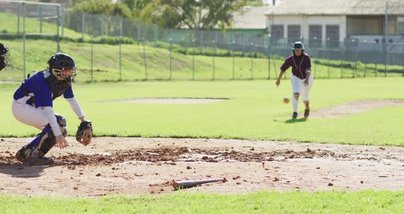 Diverse group of female baseball players, fielder attempting to catch running hitter at base