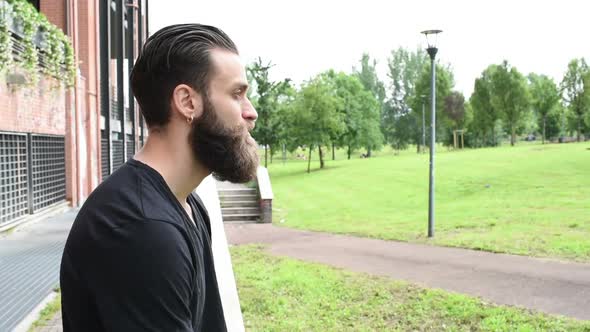 portrait young beautiful bearded man outdoor looking away