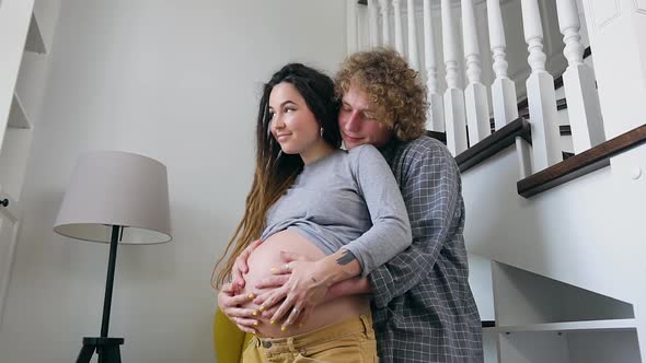 Husband and Pregnant Wife with Dreadlocks which Enjoying Future Parenthood when Their Baby Will Born