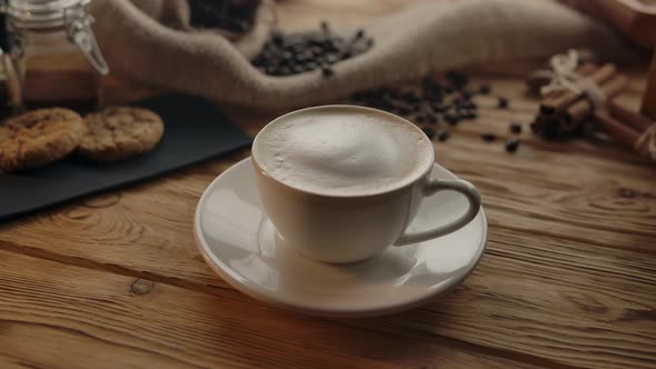 Coffee Cup Rotating on Wooden Table