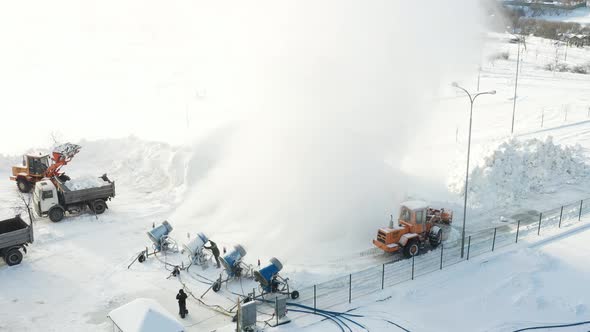 Top view of the work of four snow cannons for the production of artificial snow