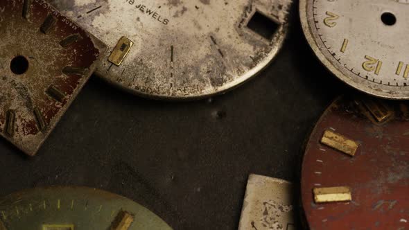 Rotating stock footage shot of antique and weathered watch faces 