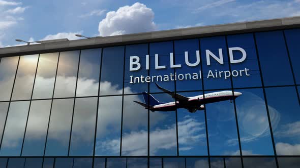 Airplane landing at Billund Denmark airport mirrored in terminal