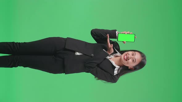 Asian Business Woman With A Smile Recommending Green Screen Mobile Phone On Green Screen