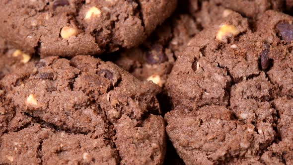 Oatmeal cookies with cocoa, chocolate and hazelnuts rotating close-up