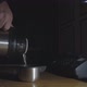 Man Pours Hot Tea From a Thermos Into a Mug on a Table in a Dark Room on Night Duty - VideoHive Item for Sale