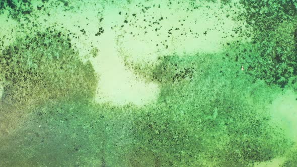 Wide angle birds eye copy space shot of a sandy white paradise beach and blue water background in hi