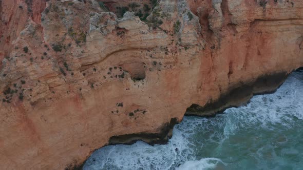 Aerial Drone Birds Eye Overhead Top Down View of Amazing Lagos Atlantic Coastline with Waves Foam