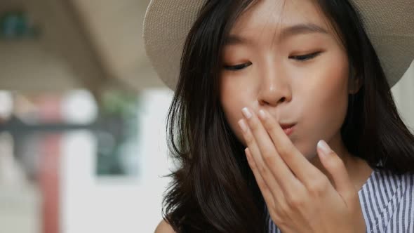 Young Asian woman eating strawberries in a cafe her very delicious.