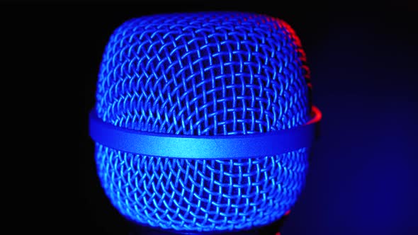 Microphone Rotates with Blue and Red Backlight. Dynamic Microphone Grid Spins Close-up