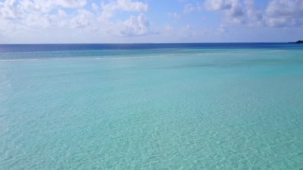 Drone aerial travel of seashore beach break by blue lagoon and sand background