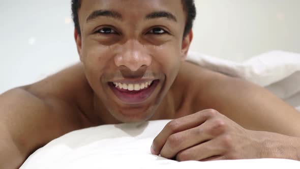 Webcam View of Online Video Chat By African Man Lying in Bed