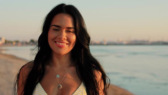 Smiling Young Woman in Bikini Swimsuit on Beach