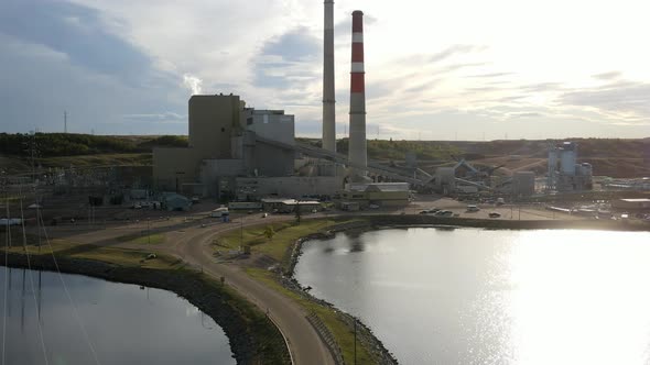 Aerial 4k dolly zoom flight towards generating station powered by coal and gas in north America. Clo