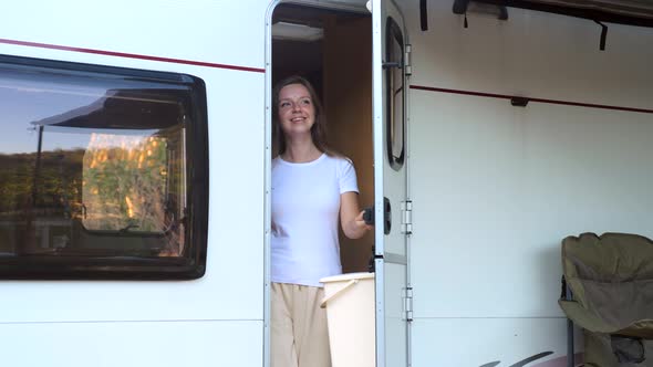 Woman Traveler Coming Out From Camper Van to Enjoy Nature