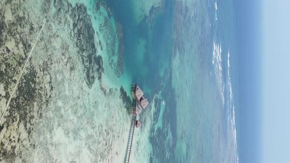 Vertical Video House on Stilts in the Ocean on the Coast of Zanzibar Tanzania Aerial View