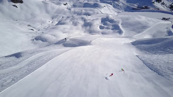 Aerial View Two Skiers Skiing on Wide Ski Slope