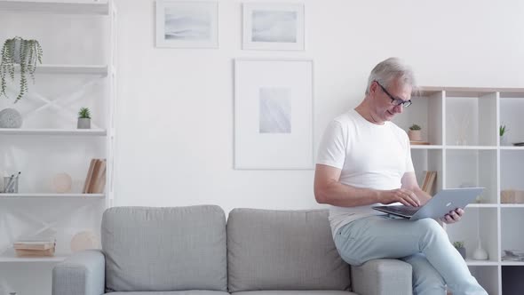 Online Communication Relaxed Man Using Laptop Home