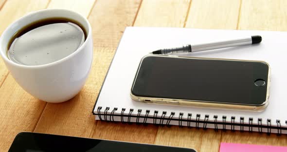 Digital tablet, coffee, diary, mobile phone, pen and sticky notes