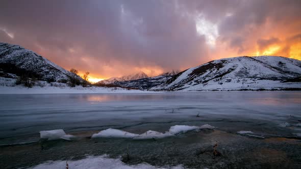 Sunset Time Lapse Over Frozen Lake With Fiery Sunset