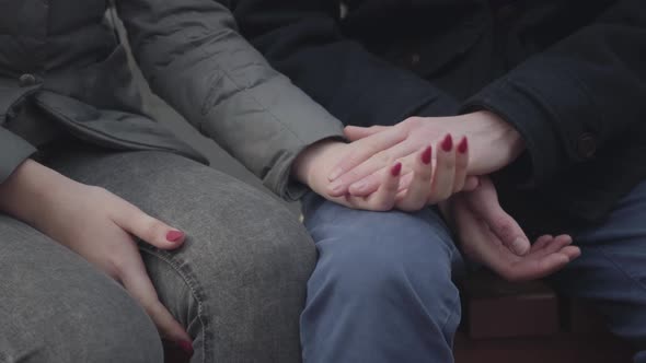 Close-up of Young Female Caucasian Hand Taking Man's Palm. Unrecognizable Teenage Girl Caressing