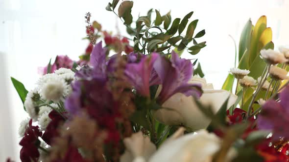 Bouquet of Roses Daisies and Lilies Decorated with Leaves