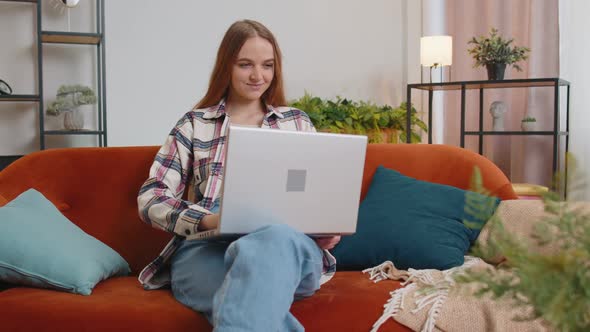 Caucasian Young Woman Sitting on Sofa Closing Laptop Pc After Work Online in Living Room at Home