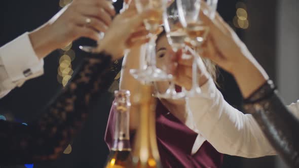 Closeup Portrait of Asian Girl Raising Glass of Champagne and Clinking Glasses with Everyone at