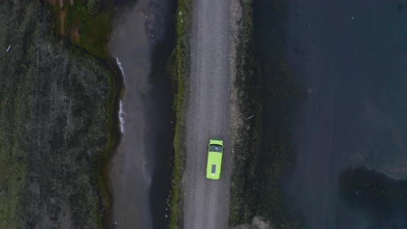 Top View Of Green Van Driving In The Unpaved Road In Iceland. - aerial