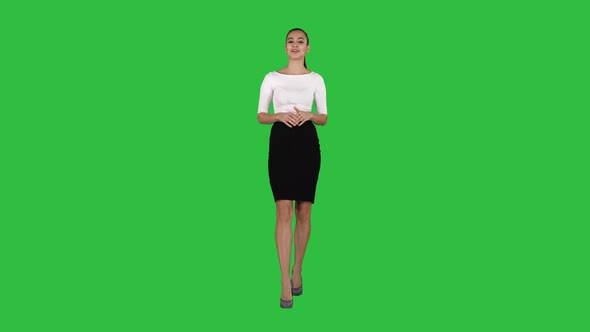 Businesswoman Walking and Talking To the Camera Explaining or Presenting on a Green Screen, Chroma